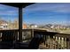 Inviting deck with seating overlooks a scenic neighborhood and open space at 11916 S Meander Way, Parker, CO 80138