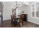 Bright dining room featuring stylish light fixture, wood table and shuttered window at 11916 S Meander Way, Parker, CO 80138