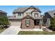 Charming two-story home with well-manicured lawn and a two-car garage at 11916 S Meander Way, Parker, CO 80138