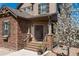 Inviting front porch with stone accents and covered entrance at 11916 S Meander Way, Parker, CO 80138