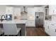 Modern kitchen featuring stainless steel appliances, quartz countertops, and ample cabinet space at 11916 S Meander Way, Parker, CO 80138