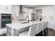 Well-designed kitchen with a large island, seating, and stainless steel appliances at 11916 S Meander Way, Parker, CO 80138