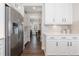 Bright kitchen with white cabinets, stainless steel appliances, and a view into the dining area at 11916 S Meander Way, Parker, CO 80138