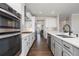 Contemporary kitchen showcasing sleek cabinetry, hardwood floors, and modern appliances at 11916 S Meander Way, Parker, CO 80138