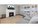 Cozy living room with fireplace, large rug, and gray sectional sofa at 11916 S Meander Way, Parker, CO 80138