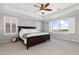 Spacious main bedroom with tray ceiling, ceiling fan, and window with neighborhood views at 11916 S Meander Way, Parker, CO 80138