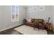 Sitting room offers ample natural light with a leather sofa and soft, bright rug at 11916 S Meander Way, Parker, CO 80138