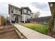 Two-story home with a spacious backyard, patio seating, garden beds, and a lush lawn for outdoor enjoyment at 4425 Quitman St, Denver, CO 80212