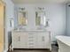 Bathroom with dual sinks, marble counters, and a soaking tub at 4425 Quitman St, Denver, CO 80212