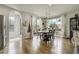 Open dining area with hardwood floors, a modern chandelier, and large windows at 4425 Quitman St, Denver, CO 80212