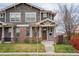 Charming two-story home featuring brick and shingle siding with a cozy covered front porch at 4425 Quitman St, Denver, CO 80212