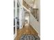 Inviting hallway with hardwood floors, staircase, and archway leading to the main living areas at 4425 Quitman St, Denver, CO 80212