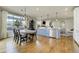 Modern kitchen and dining area with hardwood floors and a view to the living room at 4425 Quitman St, Denver, CO 80212