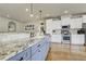 Stylish kitchen with granite countertops, white cabinets, and stainless steel appliances at 4425 Quitman St, Denver, CO 80212