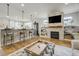 Stylish living room featuring a stone fireplace, built-in shelves, and an open floor plan at 4425 Quitman St, Denver, CO 80212