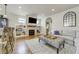 Inviting living area with a stone fireplace, built-in shelves, and comfortable seating at 4425 Quitman St, Denver, CO 80212