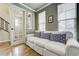 Sitting room with white sofa, hardwood floors and lots of natural light at 4425 Quitman St, Denver, CO 80212