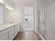Primary bathroom featuring a double vanity and a walk-in shower at 1321 Rock Cliff Ave, Erie, CO 80516