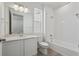 Modern bathroom featuring a shower over tub, white vanity, and a large mirror at 1321 Rock Cliff Ave, Erie, CO 80516