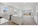 Open-concept kitchen with white cabinets, a large island, stainless steel appliances, and natural light at 1321 Rock Cliff Ave, Erie, CO 80516