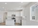 Bright kitchen with stainless steel appliances, white cabinets, and light hardwood floors at 1321 Rock Cliff Ave, Erie, CO 80516