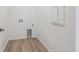 Functional laundry room with vinyl floors, washer/dryer hookups, and convenient utility connections at 1321 Rock Cliff Ave, Erie, CO 80516