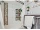 A close up view of the stylish shower/tub combination in the bathroom, with niches for storage at 7835 Barbara Ann Dr # F, Arvada, CO 80004