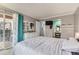 A bright bedroom with a view to the balcony and a glimpse of the en-suite dressing room at 7835 Barbara Ann Dr # F, Arvada, CO 80004