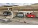 Three-car carport with assigned parking featuring three vehicles underneath at 7835 Barbara Ann Dr # F, Arvada, CO 80004