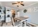 Comfortable dining area with stylish table, seating and decorative 'HOME' wall art at 7835 Barbara Ann Dr # F, Arvada, CO 80004