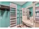 A dressing room featuring ample shelving and a vanity with a mirror, perfect for organization and getting ready at 7835 Barbara Ann Dr # F, Arvada, CO 80004