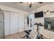 An exercise room featuring a bike, mounted tv and mirrored wall at 7835 Barbara Ann Dr # F, Arvada, CO 80004