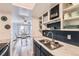 A view of the kitchen, showcasing the stainless sink, faucet and a glimpse of the adjacent dining area at 7835 Barbara Ann Dr # F, Arvada, CO 80004