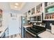 A charming kitchen featuring stainless steel appliances and open shelving for easy storage at 7835 Barbara Ann Dr # F, Arvada, CO 80004