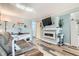 Bright living room featuring an electric fireplace, modern decor, and seamless flow to other areas at 7835 Barbara Ann Dr # F, Arvada, CO 80004