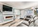Open-concept living room with a fireplace and clear view into the dining area at 7835 Barbara Ann Dr # F, Arvada, CO 80004