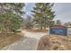 City of Arvada Memorial Park entrance featuring a sidewalk and towering pine trees, near community at 7835 Barbara Ann Dr # F, Arvada, CO 80004