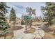 Community playground features a tall play structure surrounded by mature trees at 7835 Barbara Ann Dr # F, Arvada, CO 80004