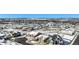 Aerial view of a snow-covered community showcasing the neighborhood layout and mountain views at 11541 Quartzite Way, Parker, CO 80138