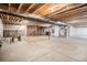 Unfinished basement with exposed beams and high ceilings at 11541 Quartzite Way, Parker, CO 80138