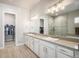 Bright bathroom with dual sinks, large mirror and glass enclosed shower with soaking tub at 11541 Quartzite Way, Parker, CO 80138