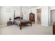Bedroom with carpet floors and a four-poster bed with an ensuite bathroom at 11541 Quartzite Way, Parker, CO 80138