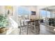 Cozy dining area featuring a wooden table, chairs, plantation shutters, and access to the outdoor patio at 11541 Quartzite Way, Parker, CO 80138
