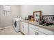 Laundry room with front load washer and dryer and extra counter space at 11541 Quartzite Way, Parker, CO 80138