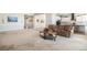 Open-concept living room with a view of the kitchen, comfortable seating and plenty of natural light at 11541 Quartzite Way, Parker, CO 80138