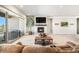 Inviting living room with a cozy fireplace, balcony access, and neutral decor at 11541 Quartzite Way, Parker, CO 80138