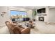 Comfortable living area featuring a fireplace, balcony access, and a relaxing seating area at 11541 Quartzite Way, Parker, CO 80138