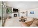 Bright living room with fireplace, large windows to a balcony, and comfortable seating at 11541 Quartzite Way, Parker, CO 80138