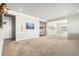 Open living room with neutral walls, carpet flooring, and views into an adjacent room at 11541 Quartzite Way, Parker, CO 80138