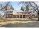 Expansive backyard with mature trees, a patio, and exterior view of the house at 7 Cherry Hills Farm Dr, Cherry Hills Village, CO 80113